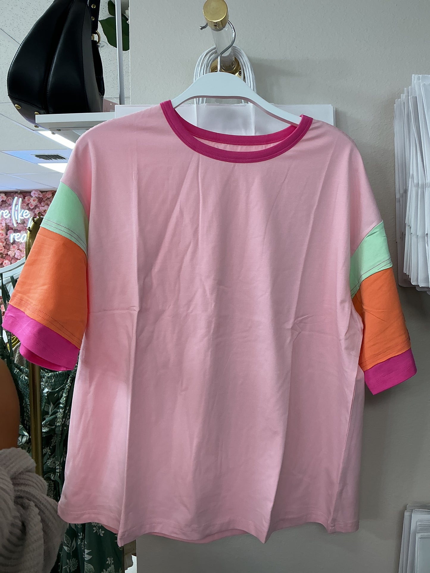 Pink shirt with colorful sleeves