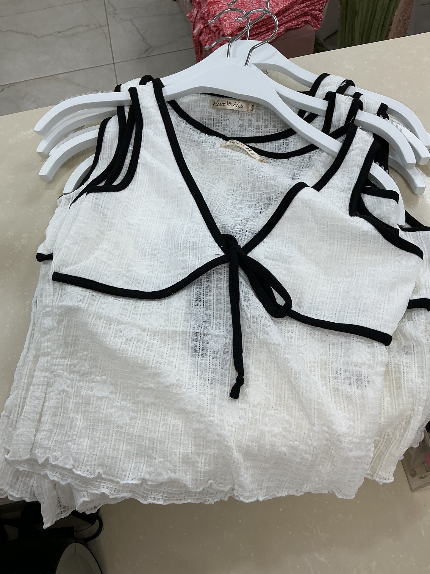 White top with black lining