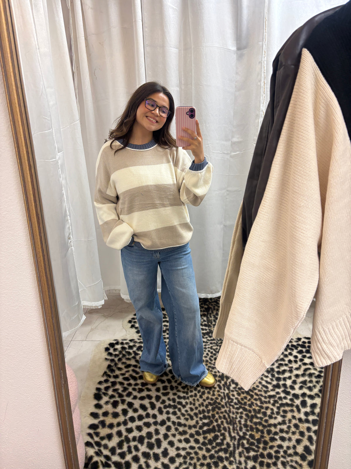 Beige and white striped sweater with a blue boarder