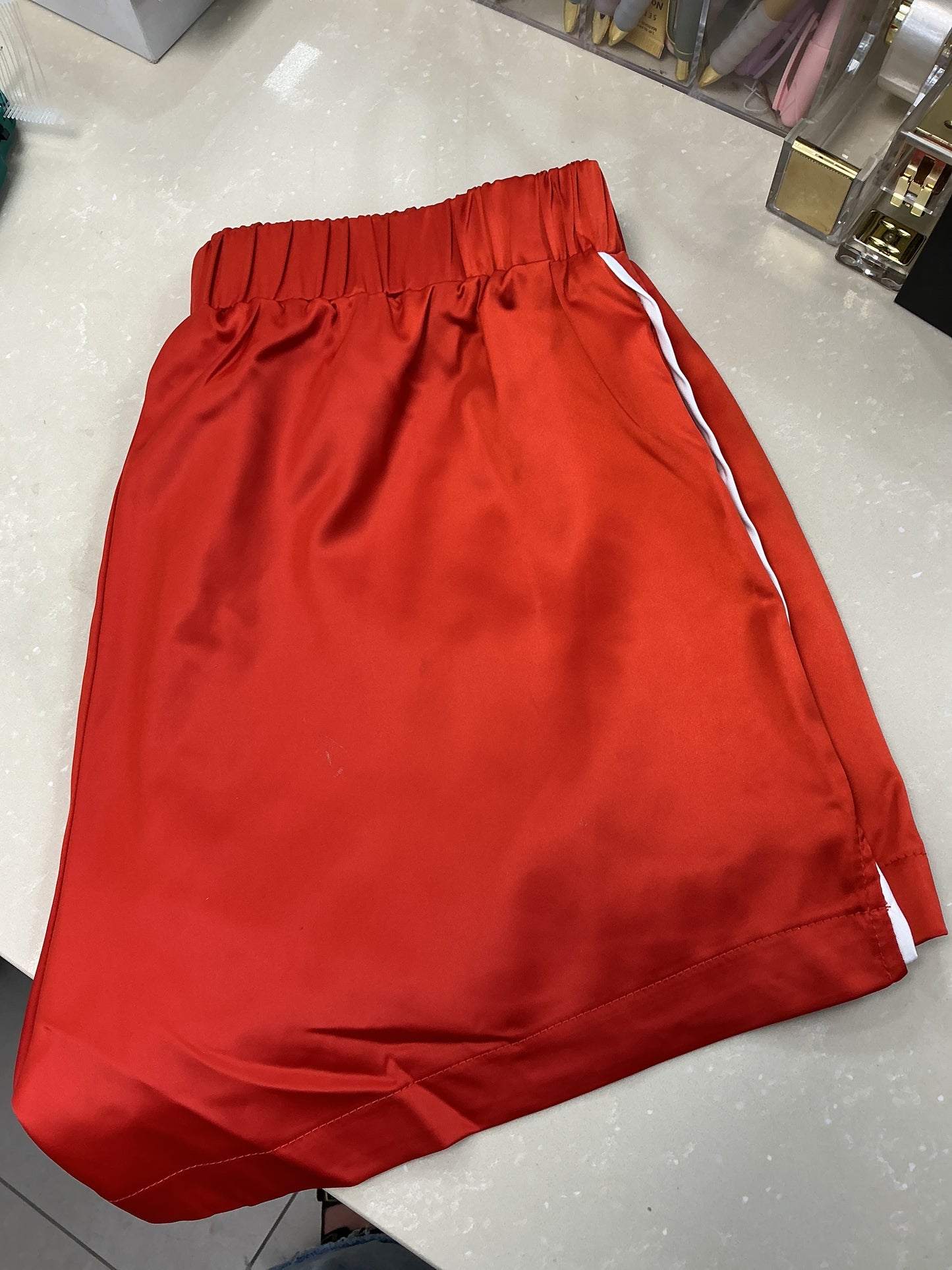Red satin shorts with stripe