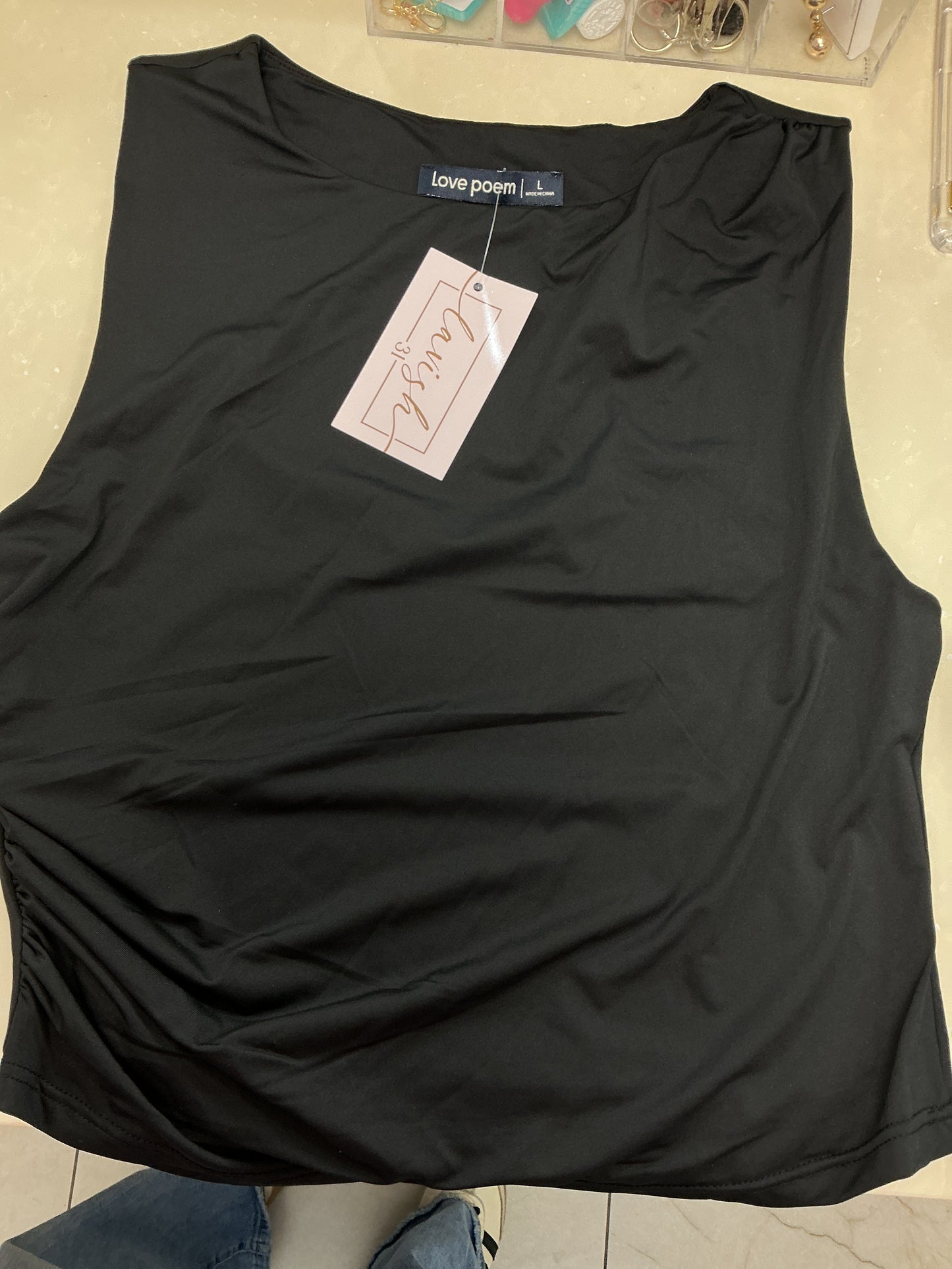 Black sleeveless top with rouching on the side