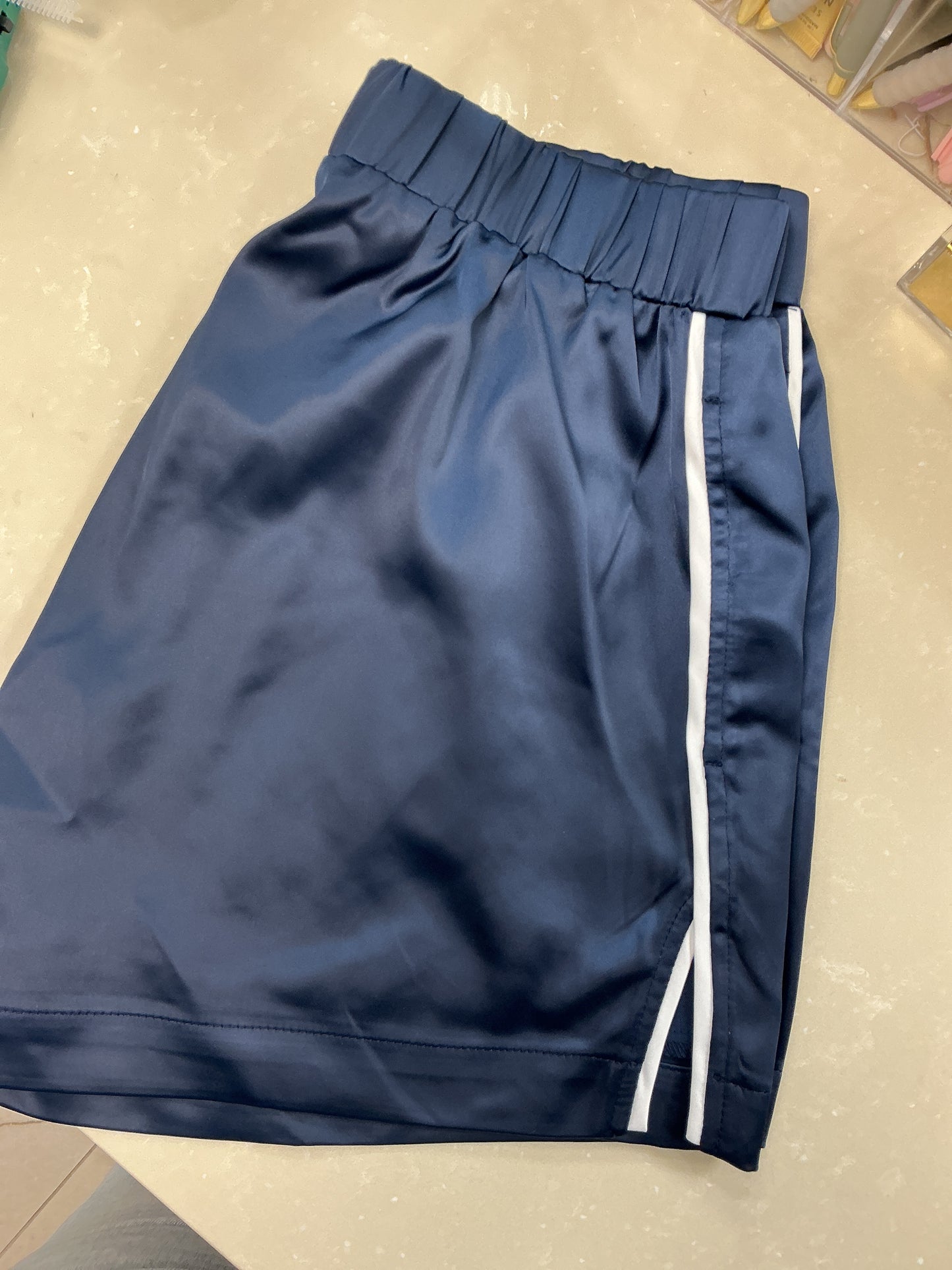 Satin blue shorts with stripe