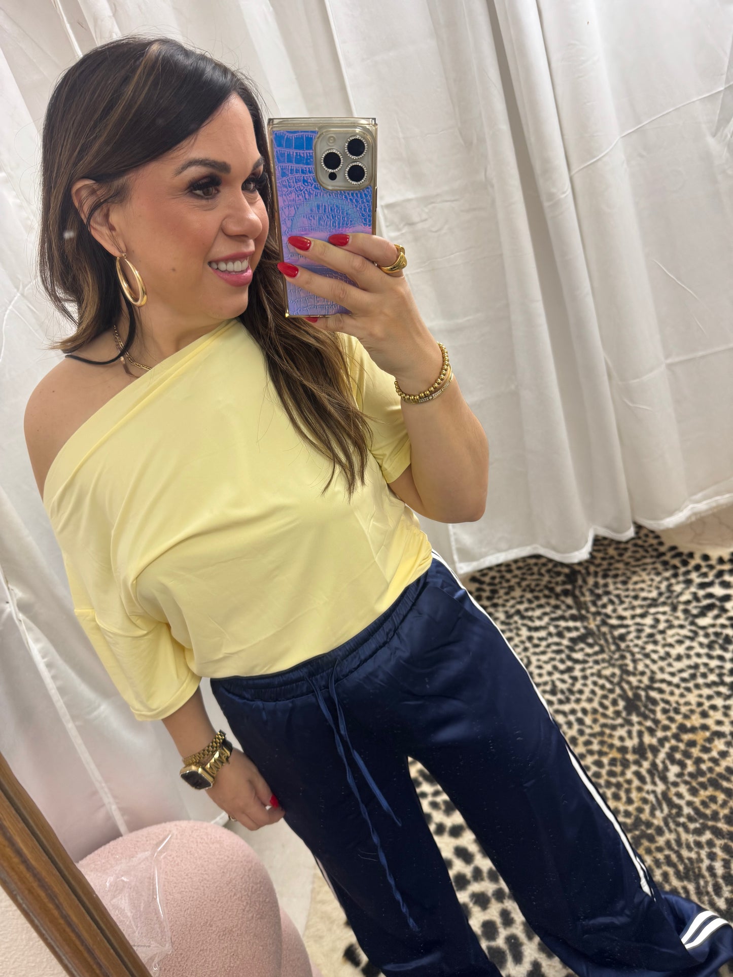 Navy satin track pants with white lines on the bottom
