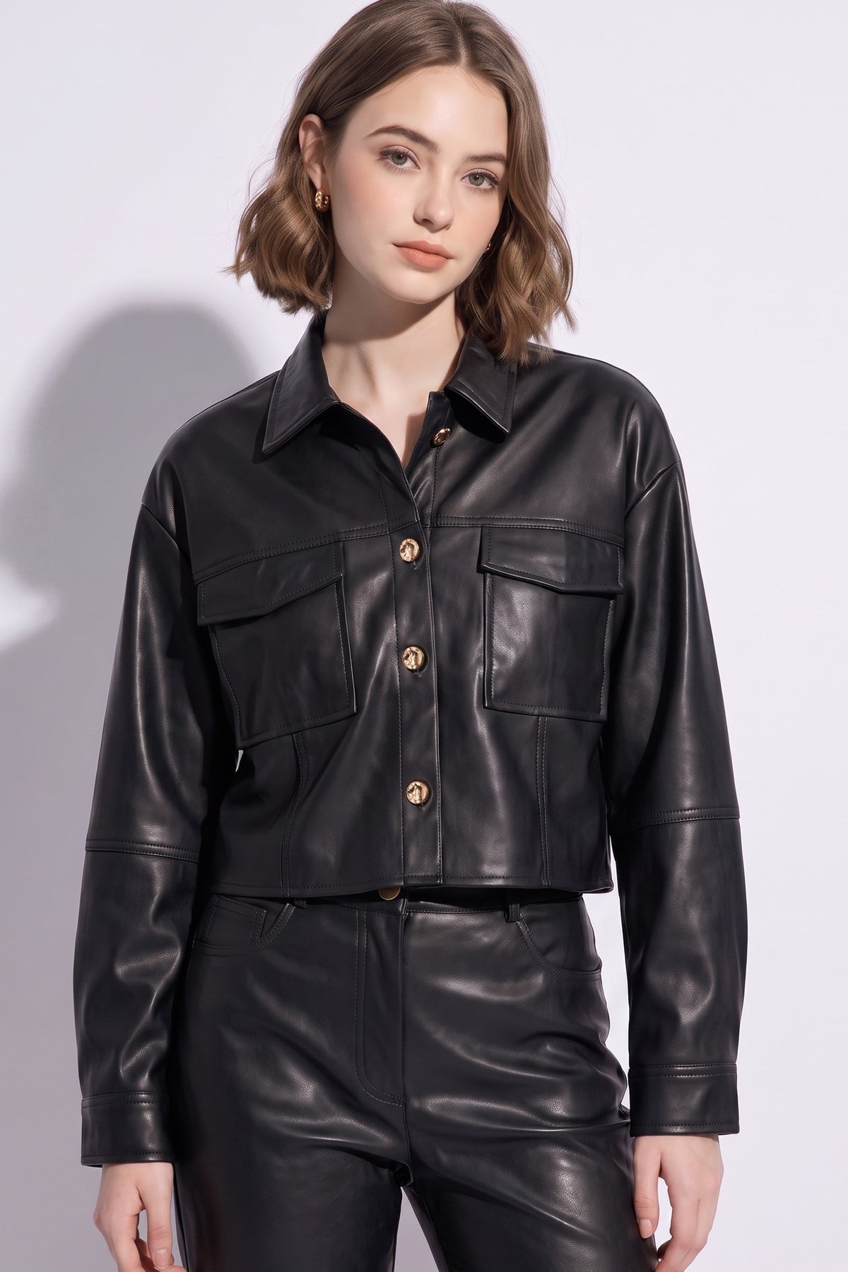 Black cropped leather jacket with gold buttons