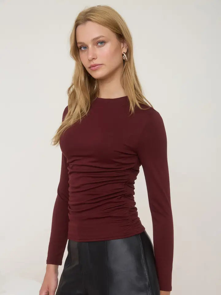 Burgundy long sleeve top with rouching on the side