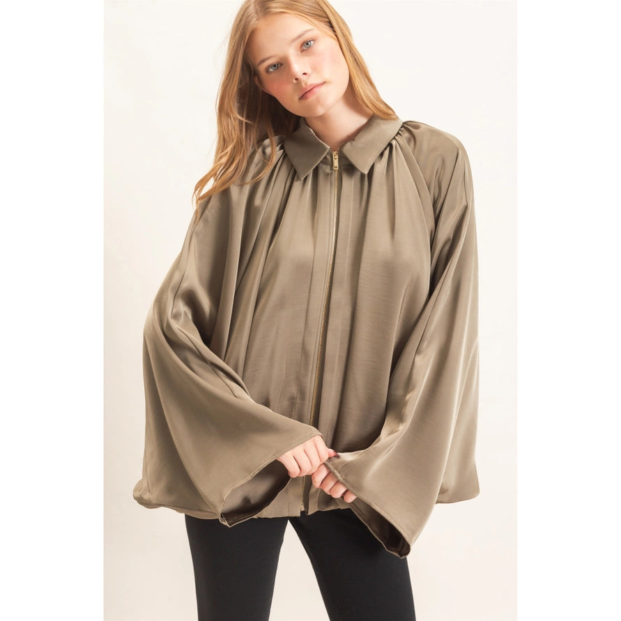 Green bat wing jacket with a gold zipper